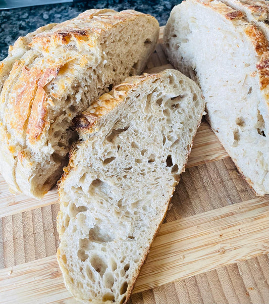 Artisan sourdough bread on cutting board, Crusty sourdough bread Pickering, Toronto bakery